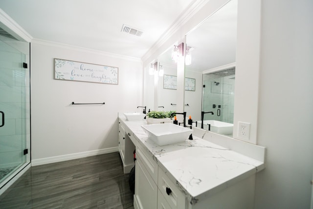 bathroom featuring hardwood / wood-style floors, vanity, a shower with shower door, and crown molding