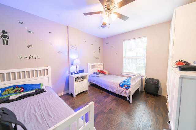 bedroom featuring ceiling fan and dark wood-type flooring