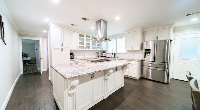 kitchen featuring island range hood, a kitchen island, white cabinetry, and appliances with stainless steel finishes