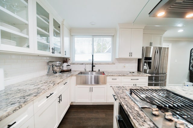 kitchen featuring light stone counters, white cabinetry, and stainless steel appliances