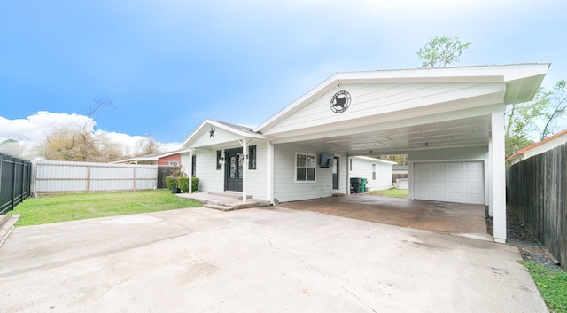 view of front facade featuring a front lawn, a garage, and a carport