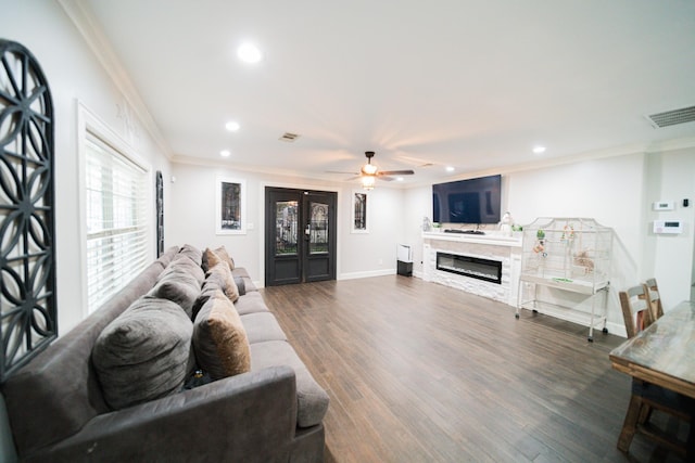 living room featuring dark hardwood / wood-style flooring, ceiling fan, and crown molding