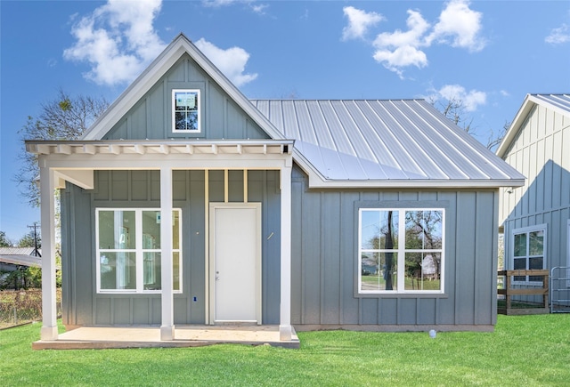 rear view of house featuring a yard and an outbuilding