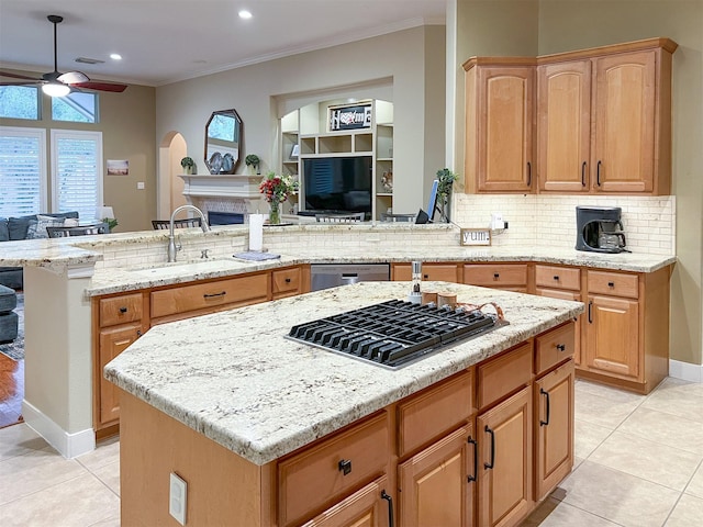 kitchen featuring kitchen peninsula, ceiling fan, sink, a kitchen island, and stainless steel appliances