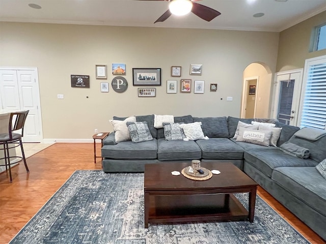 living room featuring crown molding, hardwood / wood-style floors, and ceiling fan