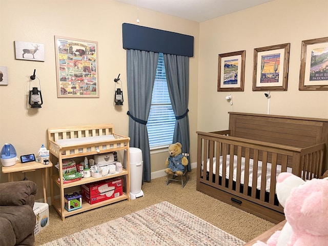 bedroom with a nursery area and carpet flooring