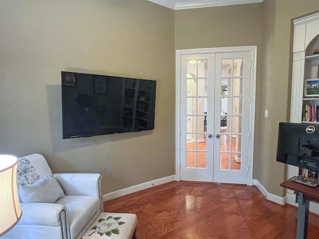 sitting room with crown molding and wood-type flooring