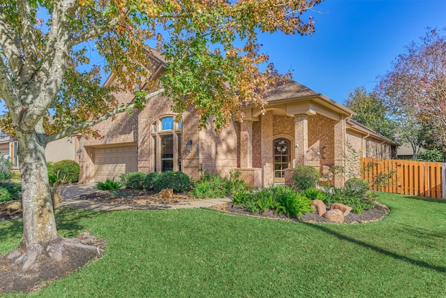 view of front of house featuring a garage and a front lawn