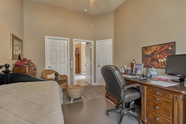 carpeted bedroom with a high ceiling