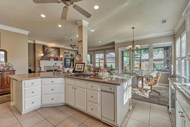 kitchen with white cabinetry, an island with sink, pendant lighting, a textured ceiling, and light tile patterned floors