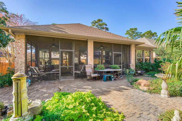 back of property with a patio area, a sunroom, and ceiling fan