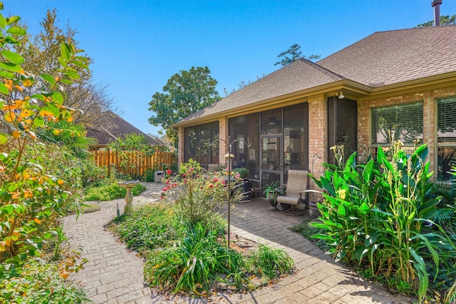 view of patio / terrace featuring a sunroom