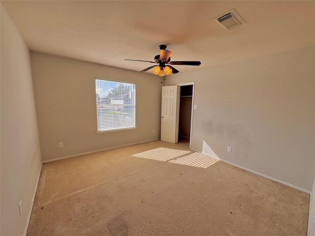 unfurnished bedroom with ceiling fan and light carpet