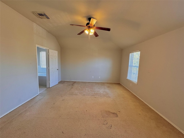 carpeted empty room with ceiling fan and lofted ceiling