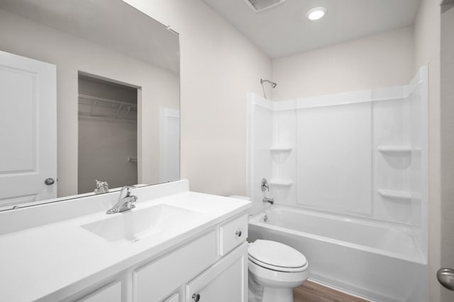 full bathroom featuring toilet, hardwood / wood-style floors, vanity, and bathing tub / shower combination