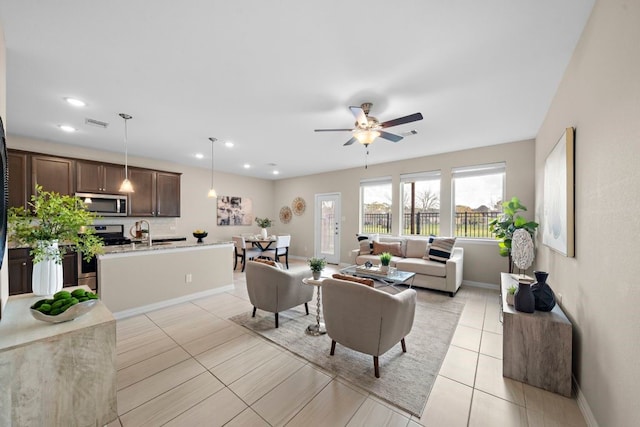 tiled living room with ceiling fan