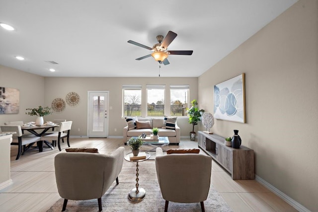 living room with ceiling fan and light tile patterned floors