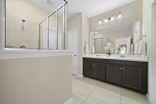 bathroom with vanity, tile patterned flooring, and a shower with door