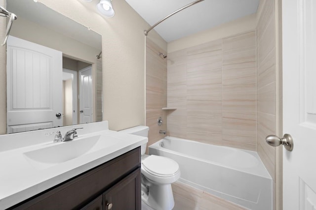 full bathroom with tiled shower / bath, vanity, and toilet