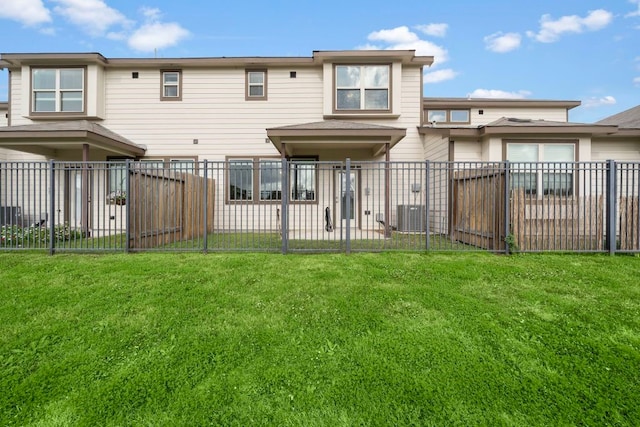 rear view of property with a yard and central air condition unit