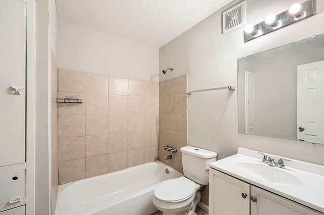 full bathroom featuring vanity, toilet, and tiled shower / bath combo