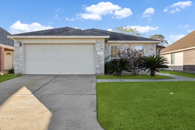 ranch-style home featuring a front yard and a garage