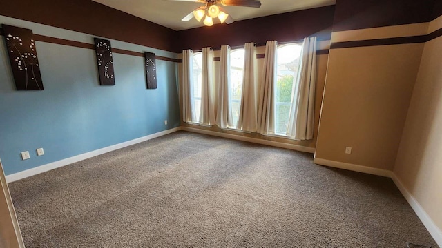 spare room featuring ceiling fan and carpet floors