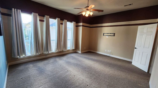 empty room featuring ceiling fan and carpet