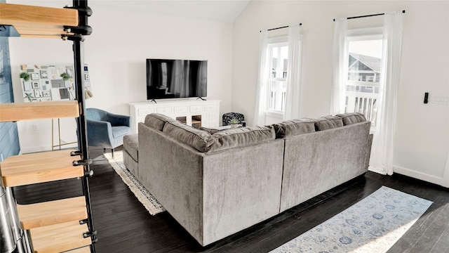 living room with vaulted ceiling and dark hardwood / wood-style floors