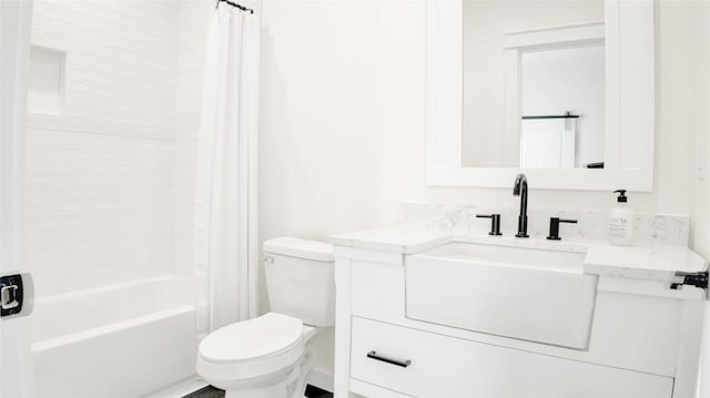 full bathroom with vanity, shower / tub combo, and toilet