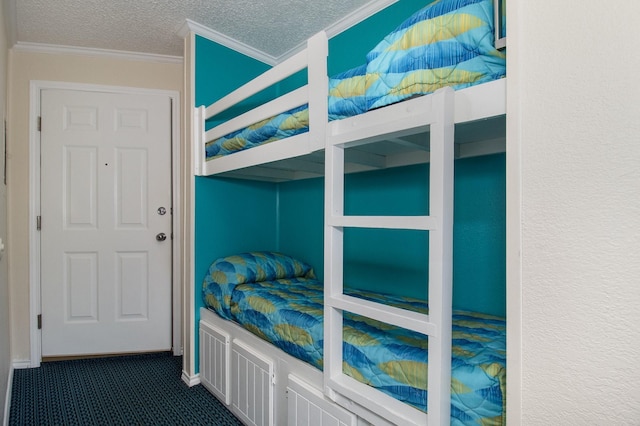 carpeted bedroom with ornamental molding and a textured ceiling