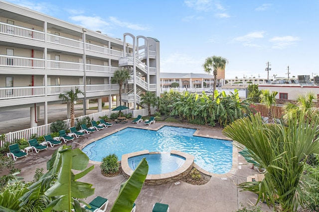 view of pool with a hot tub