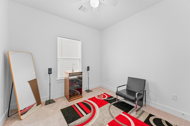 sitting room featuring ceiling fan and light carpet