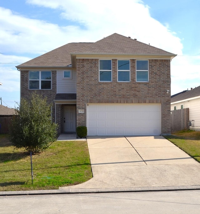 view of front of property featuring a garage and a front lawn