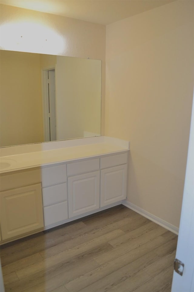 bathroom with hardwood / wood-style floors and vanity