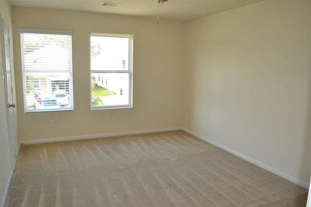 unfurnished room featuring light colored carpet