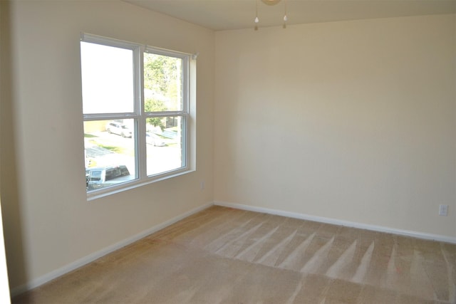 unfurnished room featuring light carpet