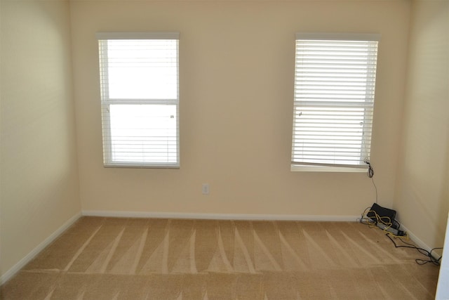 spare room with light colored carpet