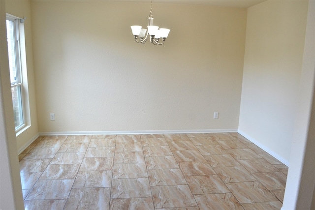 empty room with an inviting chandelier