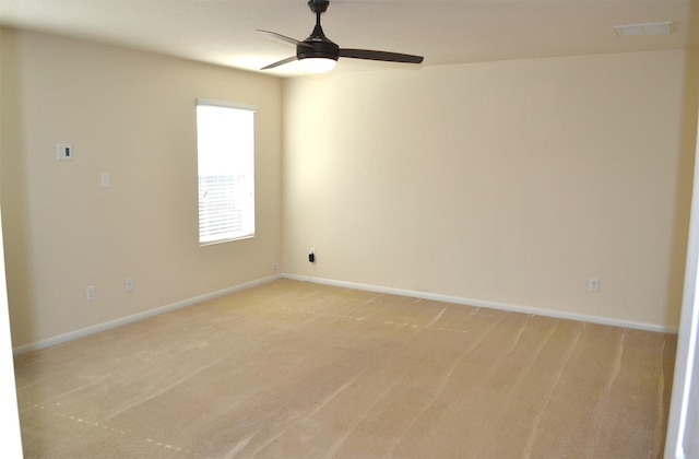 empty room with ceiling fan and light colored carpet