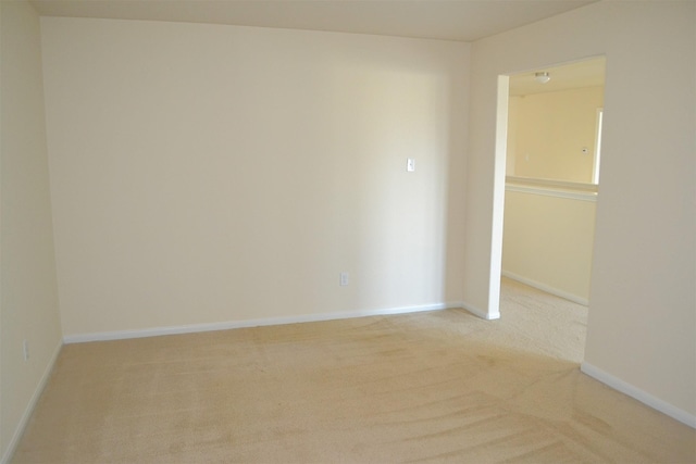 unfurnished room featuring light colored carpet