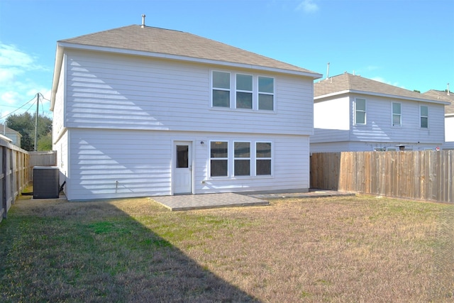 rear view of house featuring a yard and central AC unit