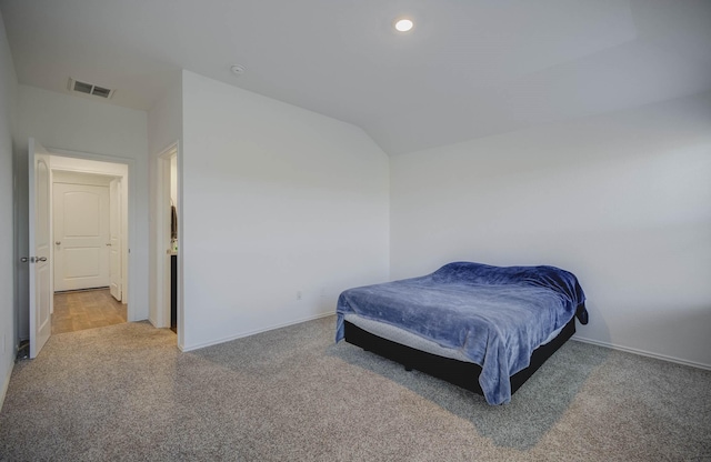 bedroom with carpet and vaulted ceiling