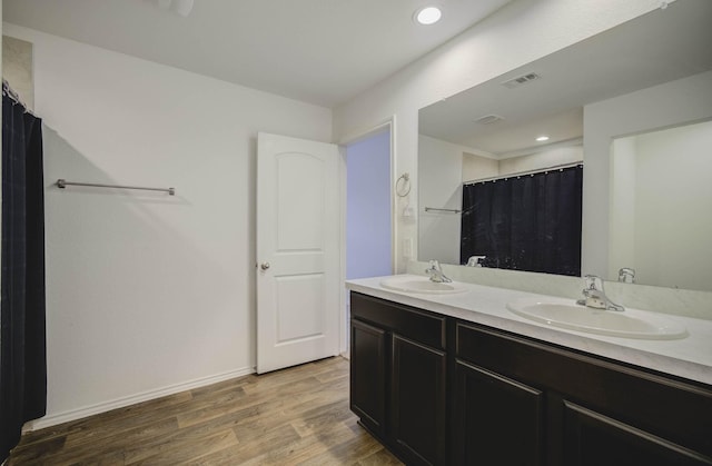 bathroom with hardwood / wood-style flooring, vanity, and a shower with shower curtain