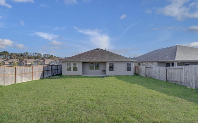 back of house featuring a lawn