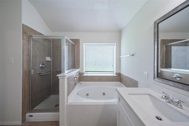 bathroom with tile patterned floors, vanity, lofted ceiling, and plus walk in shower