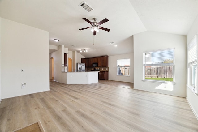 unfurnished living room featuring light wood-type flooring, ceiling fan, and lofted ceiling