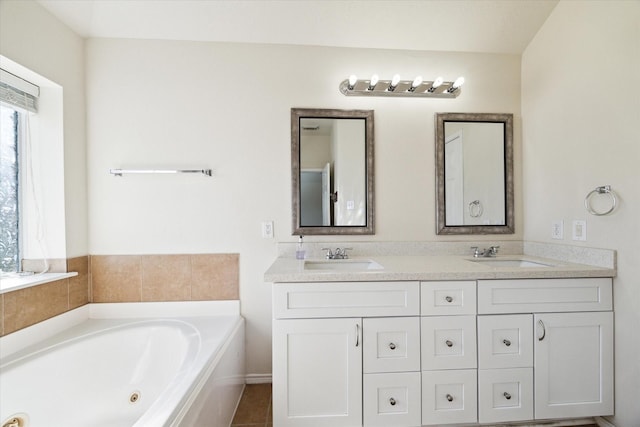 bathroom featuring tile patterned floors, a tub, and vanity