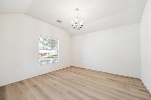 unfurnished room with light hardwood / wood-style floors, vaulted ceiling, and an inviting chandelier