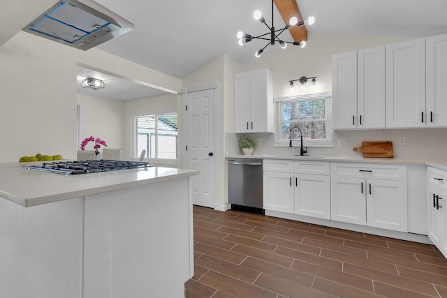 kitchen with white cabinets, backsplash, stainless steel appliances, and sink